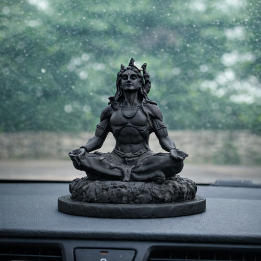 Adiyogi Shiva idol placed on car dashboard for a safe journey