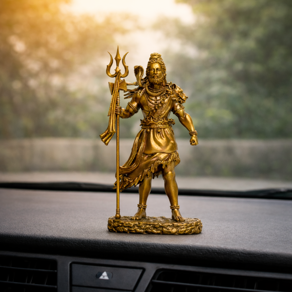 Close-up of Shiva car dashboard idol showing gold finish detail